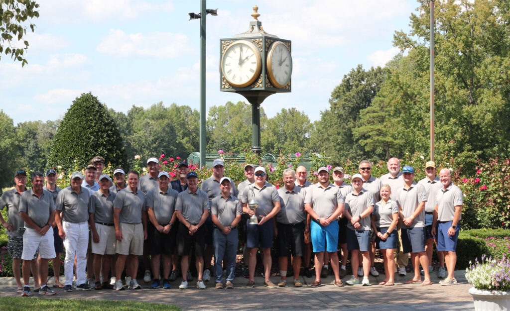 Large crowd of golfers standing in front of golf course